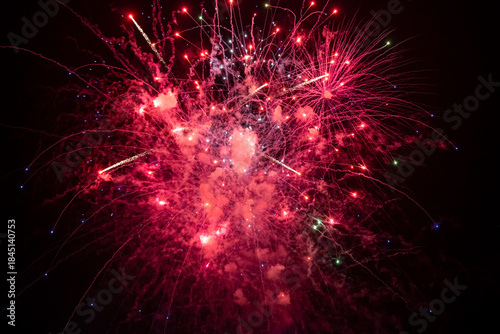 Holiday fireworks explode in the night sky. Selective focus.	