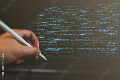 Fotografie Close-up of a man’s hands coding HTML on a laptop screen, representing web development, programming, and the work of a professional developer