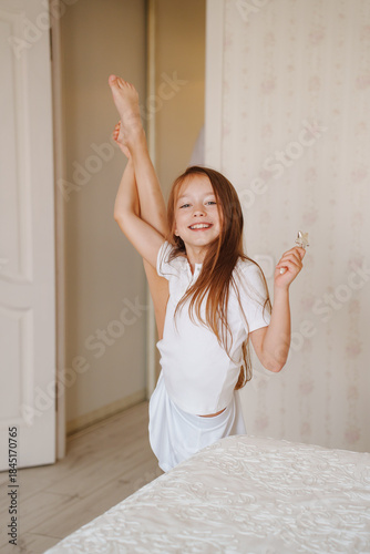 Happy child showing flexibility at home during afternoon