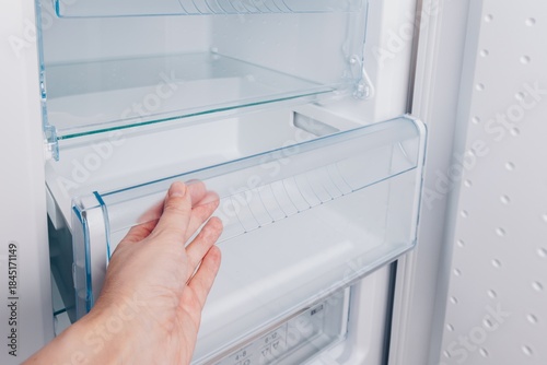 Fotografie Exploring the Inside of a Refrigerator: Checking the Fresh Food Drawer and Organ