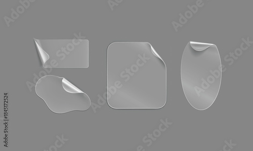 Set of various transparent blank adhesive stickers peeling off with curled corners on gray background