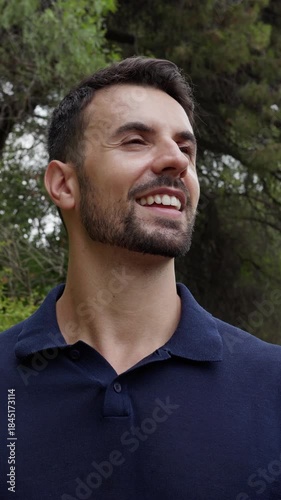 Happy young man enjoying nature smiling