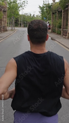 Athletic man running down an empty street in slow motion