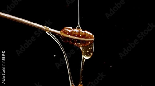 Liquid Gold's Sweet Embrace: Pure honey, a viscous nectar of nature's bounty, cascading from a wooden spoon in a dark, alluring world. The picture captures the sweetness and purity.