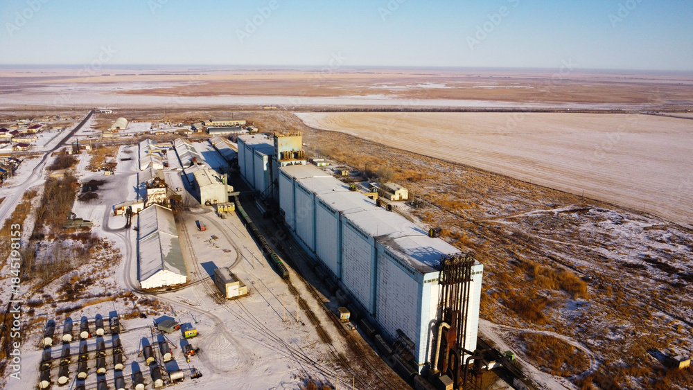 Fototapeta premium Aerial View of Large Industrial Grain Elevator and Silo Complex in Rural Landscape