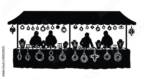 Silhouetted vendors display handcrafted jewelry at an outdoor market stall.