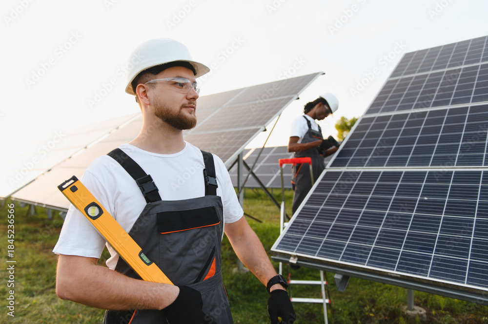 Fototapeta premium Engineers installing solar panels for renewable energy