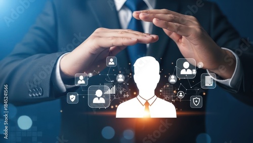 Businessman protects digital human resources network with glowing icons.
