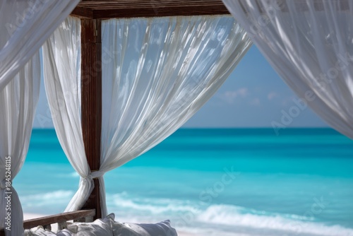Open beach cabana with white curtains flowing gently in the sea breeze, framing a turquoise ocean view.