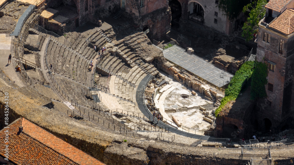 Fototapeta premium Aerial closeup of the Amphitheater of Catania, in Sicily, Italy. It is an ancient amphitheater in Southern Italy, built in the Roman Imperial period. It is located in the historic center of the city.