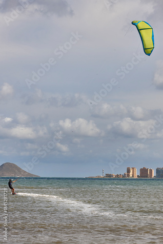 Mature man practicing kitesurfing. Aquatic sport. Athletic healthy senior