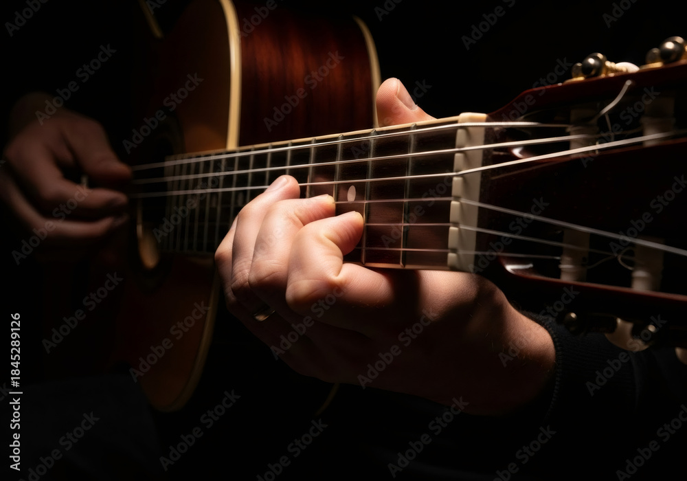Fototapeta premium Man playing acoustic guitar, close-up of hands on fretboard as a musician performs music. Musical instrument for concert poster or album cover.