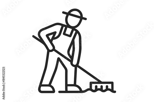 Gardener or farmer working the soil with a rake wearing overalls and a sun hat