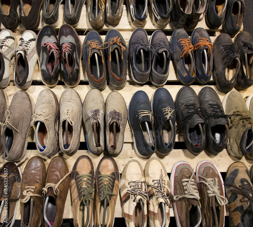 Wide angle shot of numerous pre-owned, vintage, and modern footwear, including many styles
