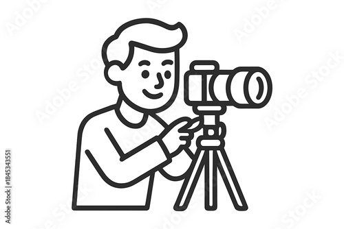 Smiling man operating a professional camera on a tripod stand for media production