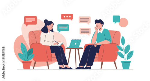 A therapist listens attentively to a male patient during a counseling session, taking notes on a notepad while a laptop sits nearby.