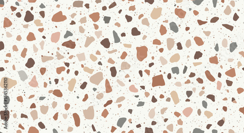 Terrazzo surface featuring irregular multicolored chips scattered across a pale background forming a speckled decorative pattern.
