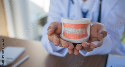 Fotografie Dentist examining patient’s teeth, explaining oral health issues, reviewing x-rays, planning treatment, providing friendly dental care, diagnosis, orthodontic assessment, therapy