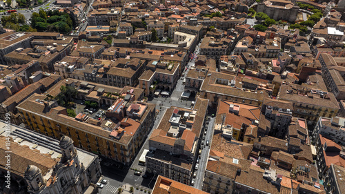 Fototapeta Naklejka Na Ścianę i Meble -  Aerial view of the streets between the buildings and houses of the historic center of Catania, Sicily, Italy. it is sunny day morning.