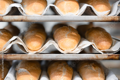 Obraz na płótnie Close up view of   Freshly baked bagels on a metal rack in a bakery