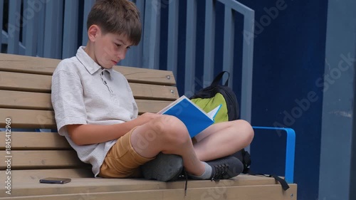 Reading books during the summer holidays, Boy reading a book