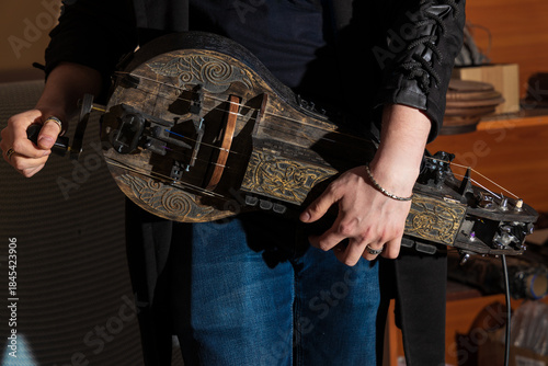 Bild auf Leinwand hurdy-gurdy player male hands musician play authentic instrument artistic aesthe