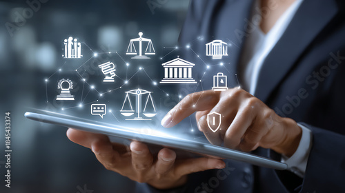 Person interacting with digital legal icons on tablet justice technology