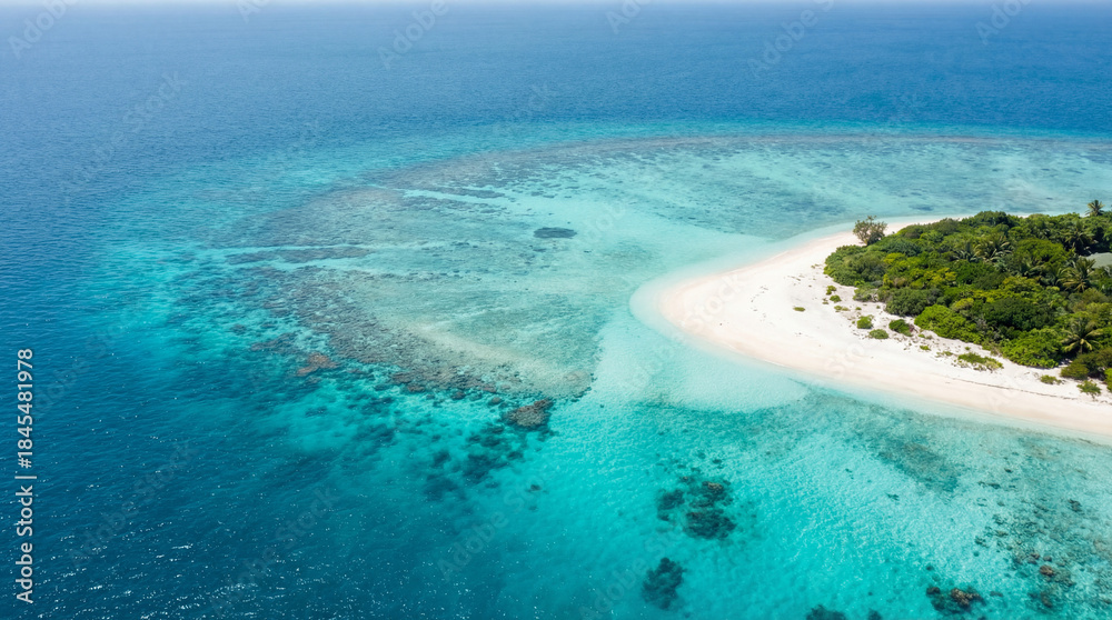 Fototapeta premium Aerial view of tropical island beach with turquoise lagoon and coral reef