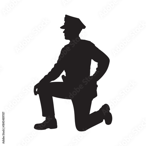 A silhouette of a man kneeling possibly a police officer or soldier