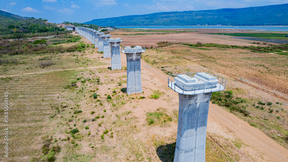 Naklejka premium The concrete pillars/piers for the high-speed rail track are under construction at the unfinished construction site.