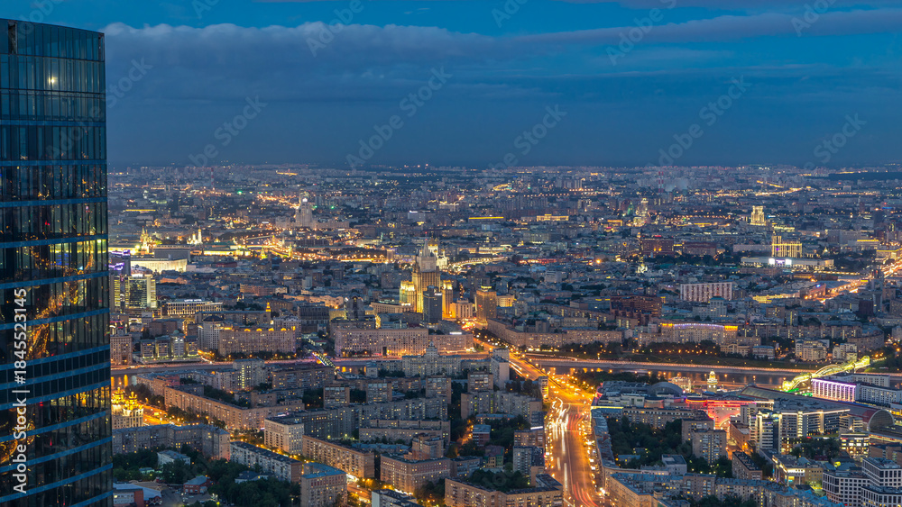 Fototapeta premium Aerial top view of Moscow city day to night timelapse after sunset. From the observation deck