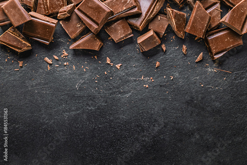 Photos Dark chocolate chunks on black slate background