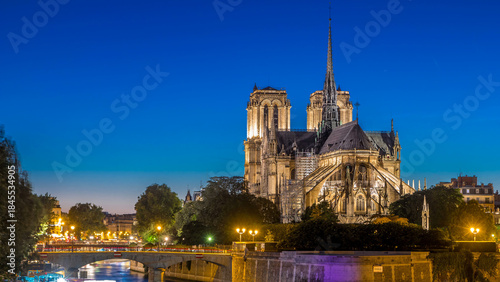 Sticker Rear view of Notre Dame De Paris cathedral day to night timelapse after sunset