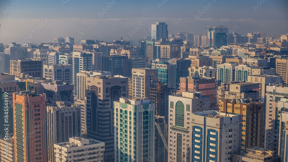 Fototapeta Skylines under the thick fog at the street timelapse of Abu Dhabi at morning
