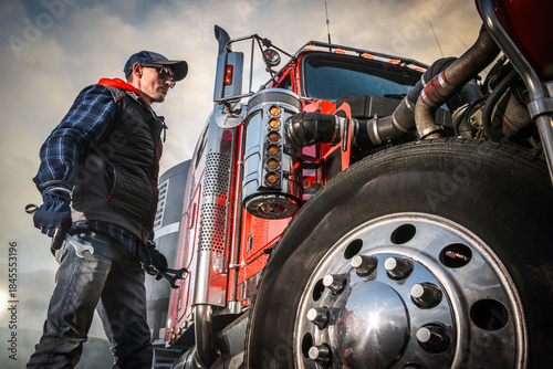 Canvastavla Man Working on a Red Semi Truck in an Outdoor Location