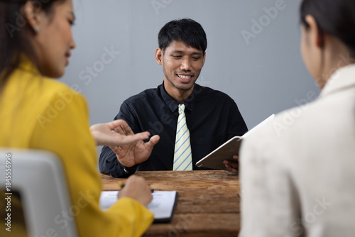 Canvas Print Lawyer explaining contract details to clients during meeting