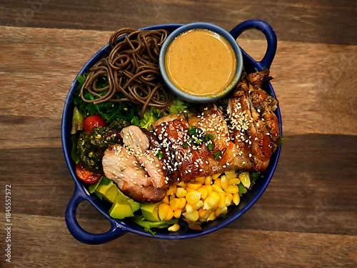 Grilled chicken salad with fresh vegetables and pasta.