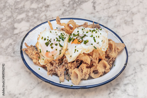 Quadro su tela The essence of seafood tapas: calamari rings coated in a thin layer of flour and