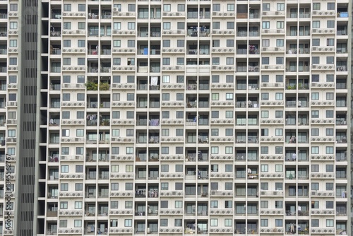 Exterior façade of a residential high-rise building of Condo U (a brand or series name of the Thai real estate developer Grand Unity Development Co., Ltd. (often abbreviated Grand U), Bangkok Yai district, the old town of Bangkok, Thailand