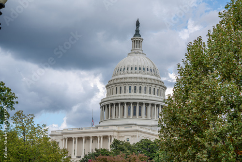 U.S. Capitol Dome Framed by Trees Under Cloudy Sky
