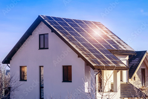 Solar Panels Roof in Winter. Frosty and Sunny Winter Day is Good for Solar Panels. Solar panels Photovoltaic Cells are covered with Frosty Frost. The Effect of solar in the Cold Weather. 