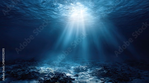 this is an underwater photograph showcasing a deep sea environment. the main focus of the image is a ray of sunlight shining down from above