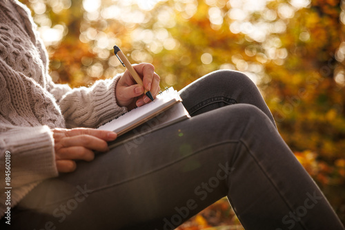 Tableau sur toile Woman writing diary outdoors
