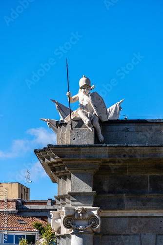 Cherub sculpture on top of Puerta de Alcala arch in Madrid