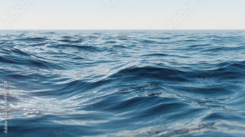 An expanse of blue ocean water with small waves and a clear sky