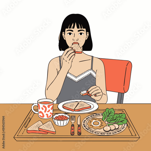 Woman eating breakfast alone at a table with toast and tea