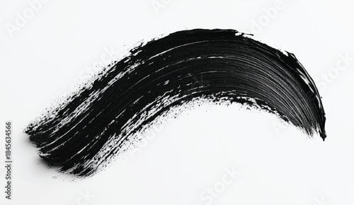 Brushstrokes of black oil paint on white background, top view