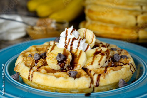 A golden waffle with bananas, peanut butter, chocolate syrup drizzle, and chocolate chips creates a decadent treat in Waukesha County, Wisconsin.