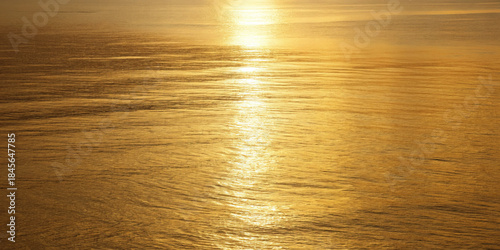 Gold water golden sunset shimmering reflection calm sea warm light serene horizon golden hour gentle ripple tranquil mood minimal nature bathe calm water warm light with shimmering reflection