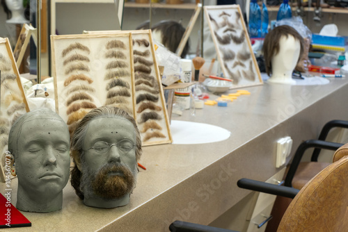 Make-up studio with mannequins, eyebrows and wig samples in a beauty workshop for film and theater actors